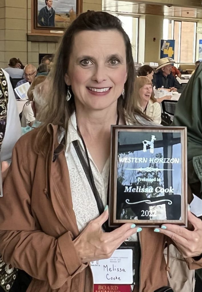 Melissa Cook holding her New Horizon award in June 2022