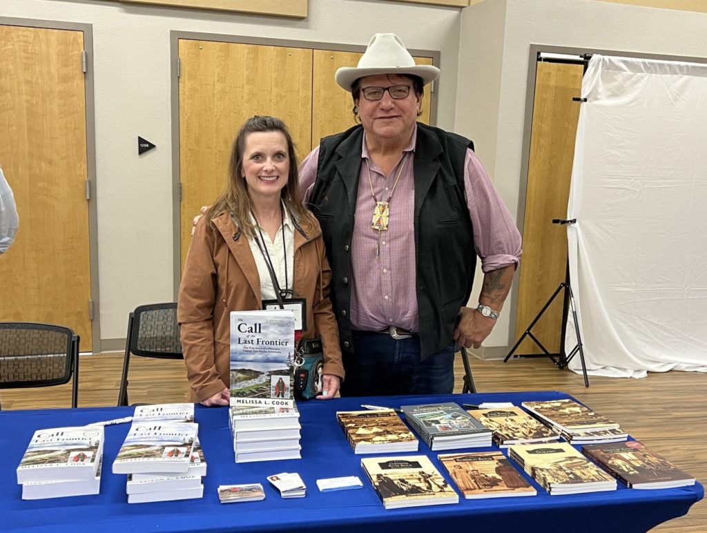 Melissa Cook and Donovin Sprague stand by their books at the Wyoming Writers' conference in June 2022.