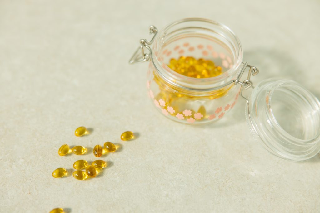 Vitamin D pills in a jar and on a table