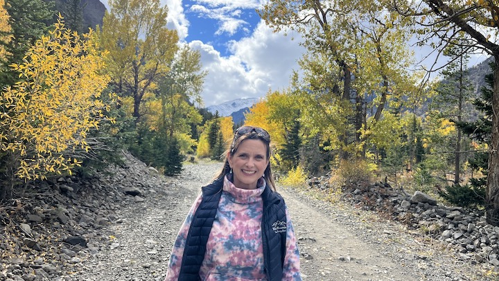 Melissa Cook stands on the Kirwin, Wyoming road during fall colors 2022
