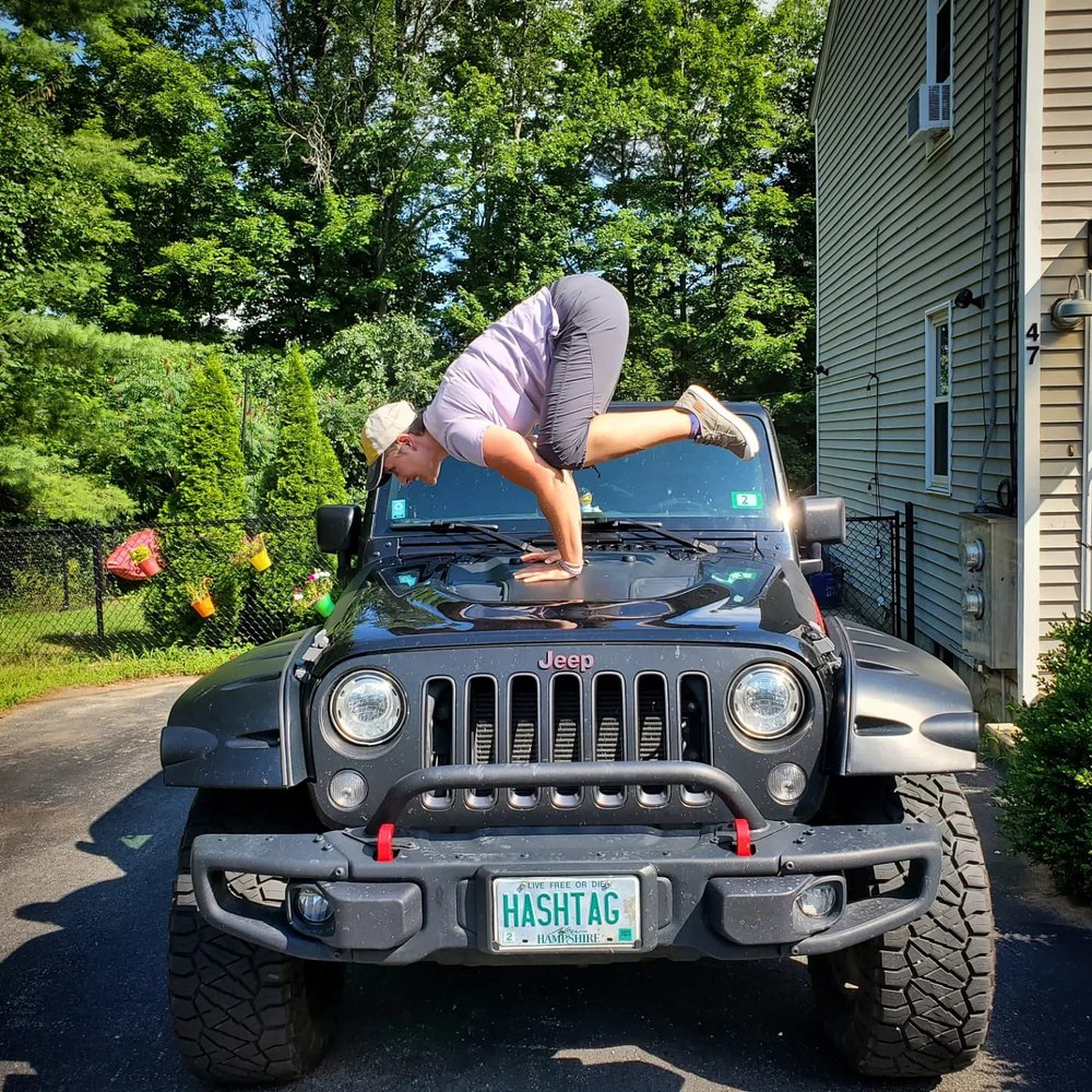 Sarah Locke does a yoga pose on her Jeep hood.