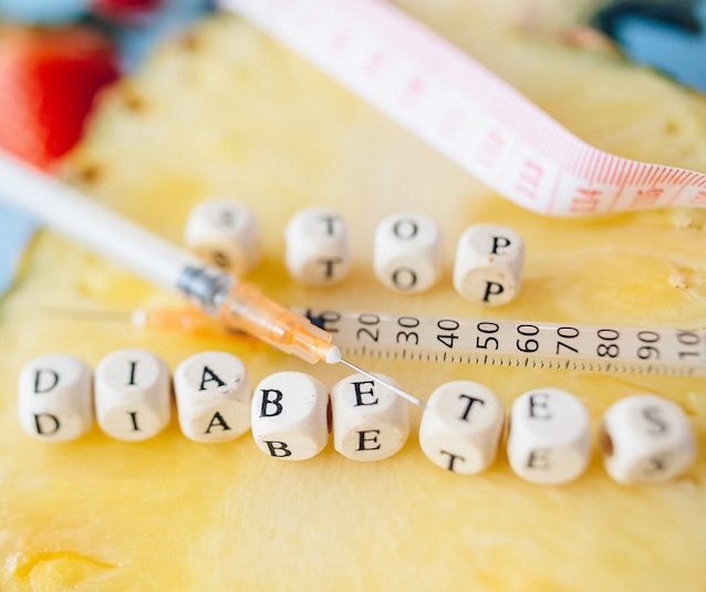 Diabetes spelled in blocks with a syringe