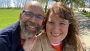 Dan & Jen Digmann sitting together in a park