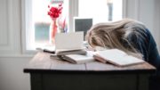 Woman with head on desk from fatigue