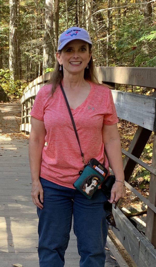 Melissa Cook standing on a bridge in New Hampshire in October 2021