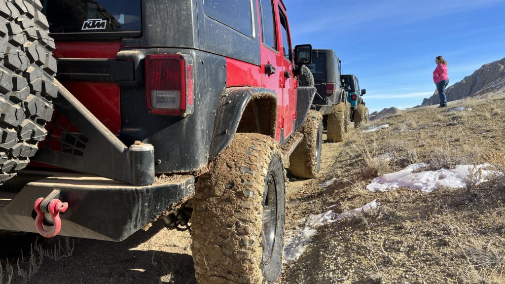 Three Jeeps with muddy tires