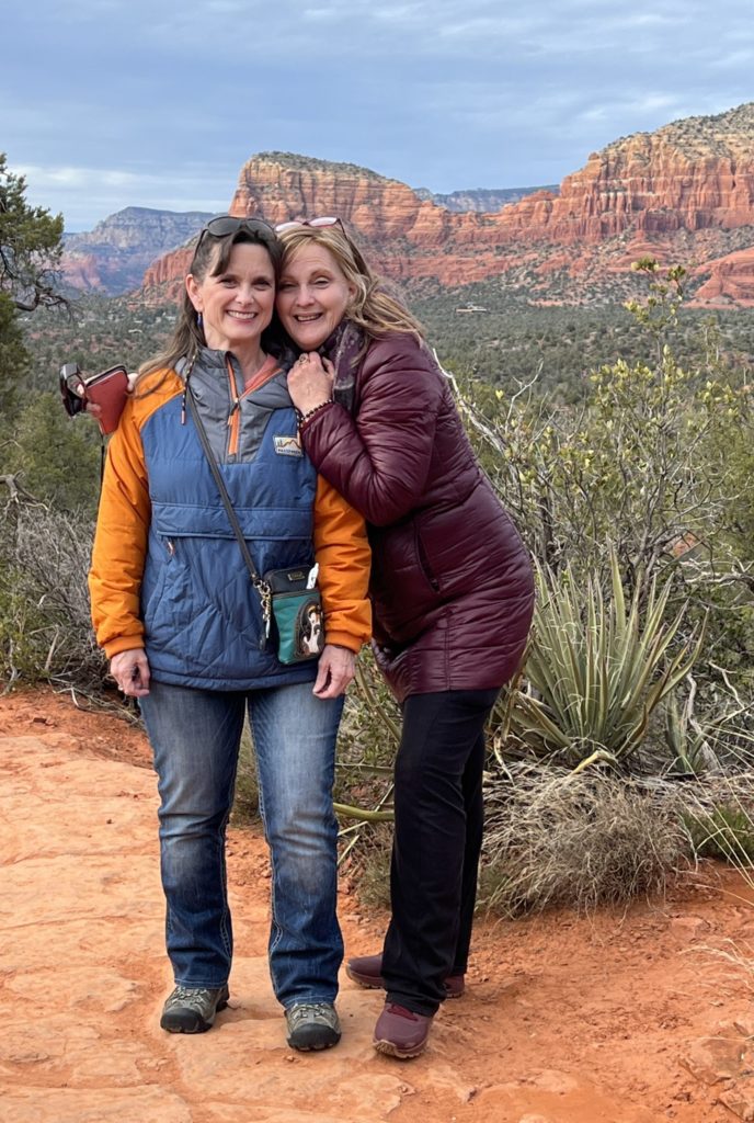 Melissa Cook & Phoenix Rose stand by the red rocks in Sedona, Arizona