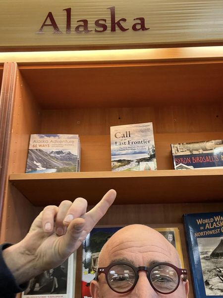Ron Wallace pointing to my book on the top shelf in Mosquito Books